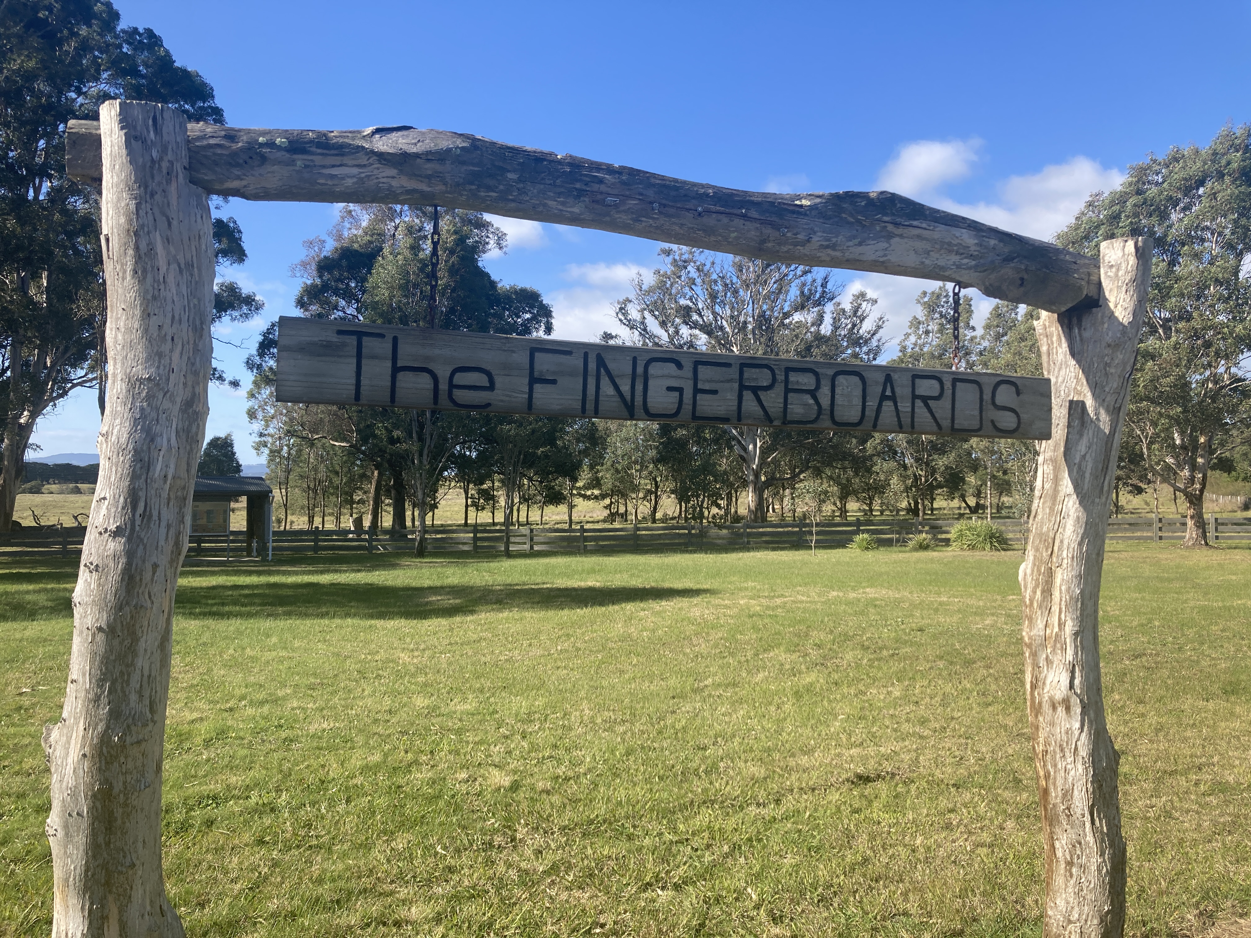 A wooden sign made of logs with "The Fingerboards" written on it. 
