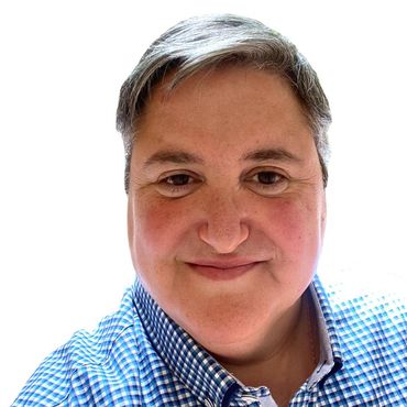 heahshot of Tony Briffa Grey/black hair blue shirt