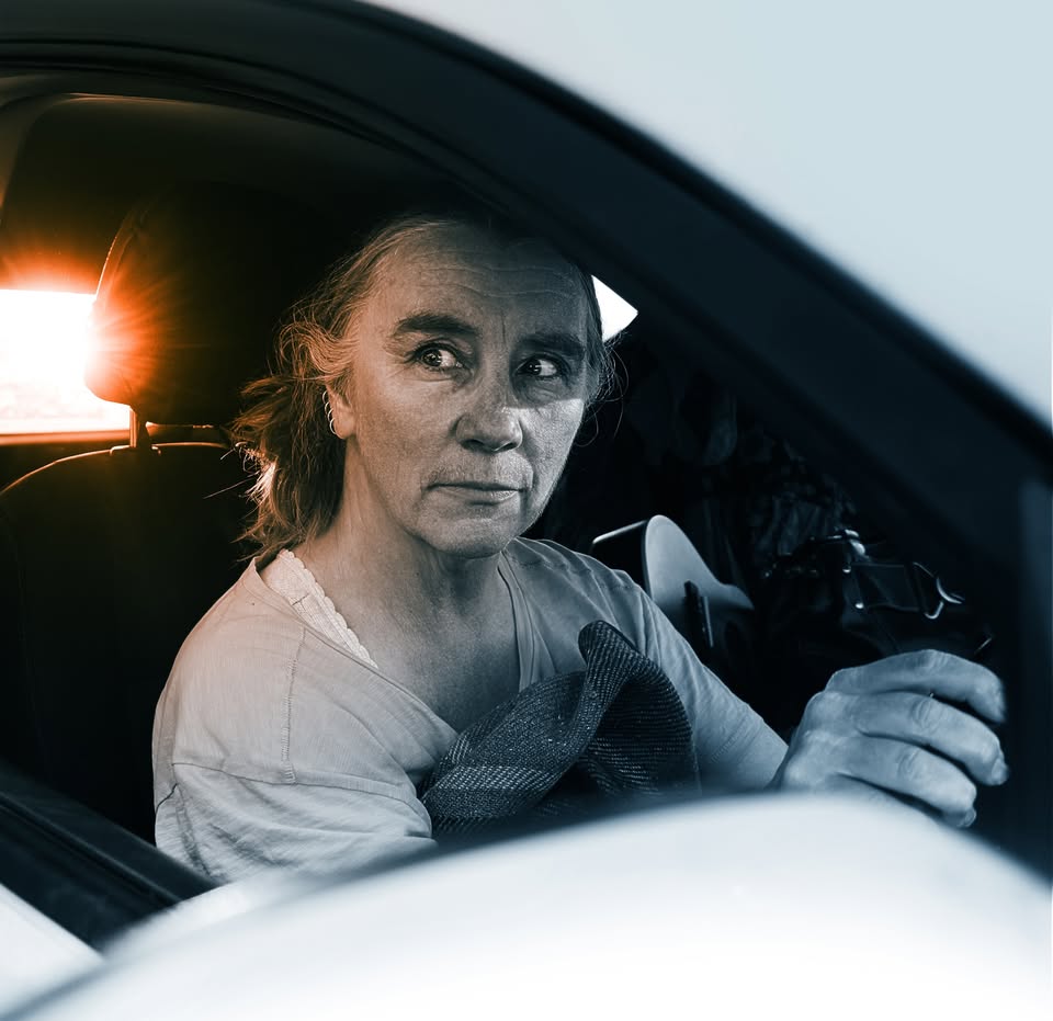 Penelope Swales at steering wheel in car