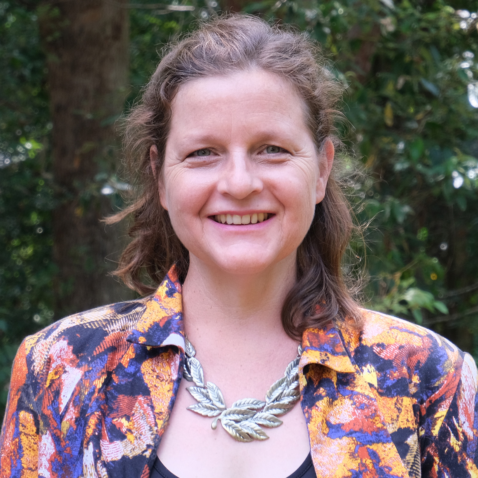 Bonnie Hart multi-coloured shirt trees in background