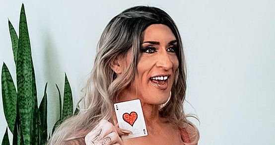 Head shot of Gabbi Tuft long silver coloured hair plant in background