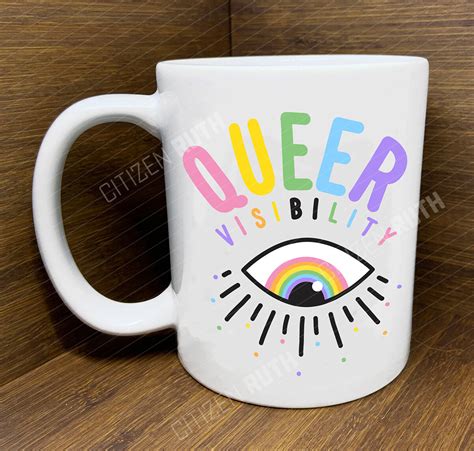 beverage mug with word queer in rainbow colours and eye with lashes