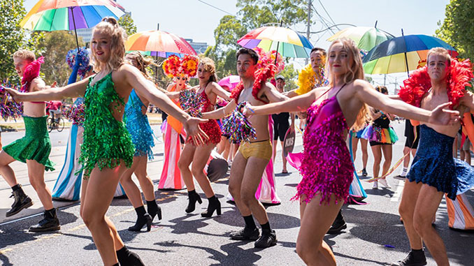 picture of people dancing hand in hand at Pride