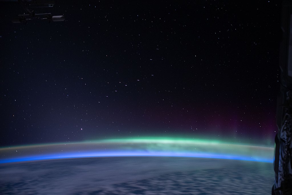 A train of Starlink satellites in low Earth orbit, as seen from the International Space Station – with bonus Aurora australis (Photo by NASA, Public domain, via Wikimedia Commons)