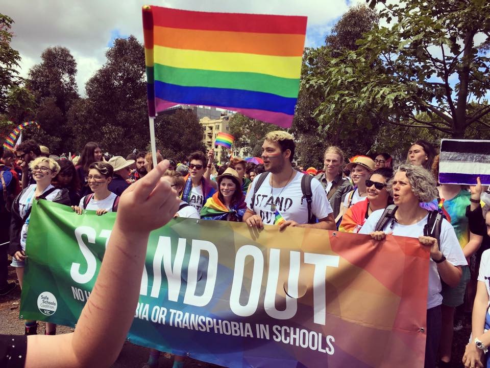 Image of Stand Out group holding rainbow flag