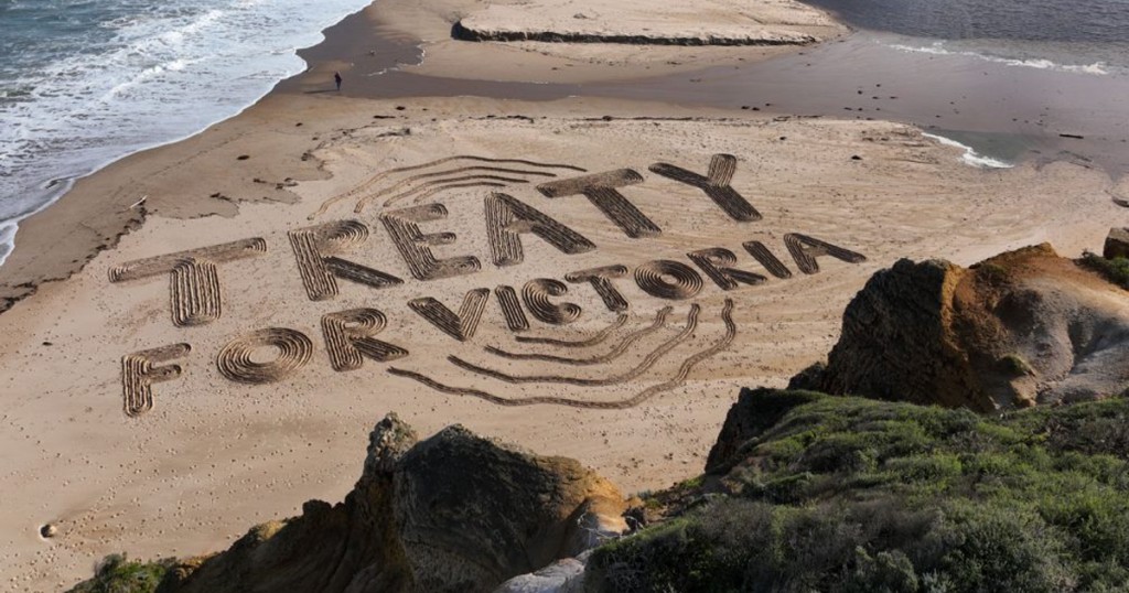 Sand drawing of 'treaty for victoria' along the beach