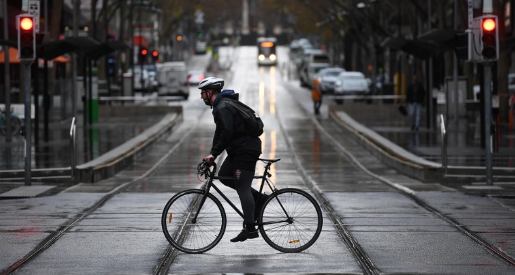 A cyclist on Bourke Street in Melbourne. Image credit: AAP/James Ross