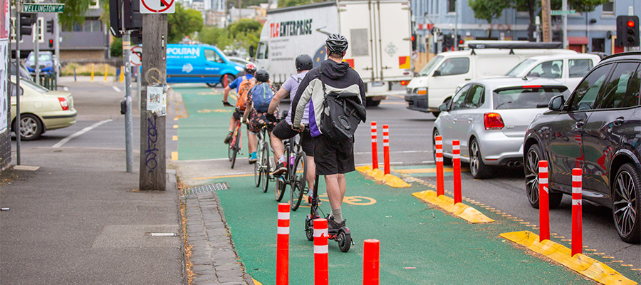Bicycle and scooter riders waiting in a protected lane. Image credit: Yarra City Council
