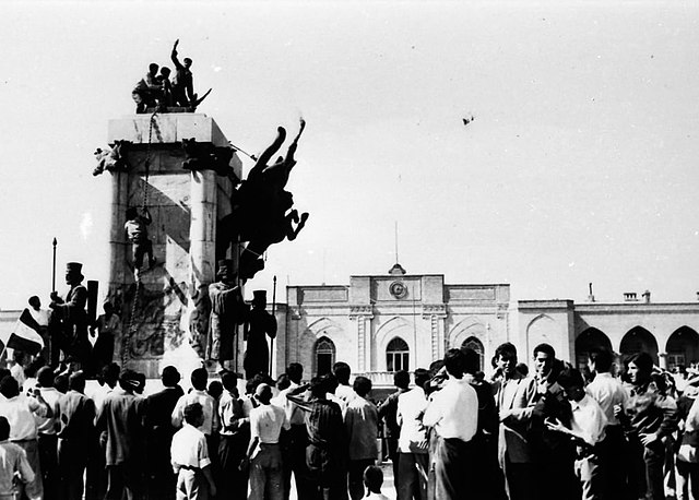 People from the Iranian army Pulling down statues of the Reza Shah surrounded by a crowd in Iran, 1953
