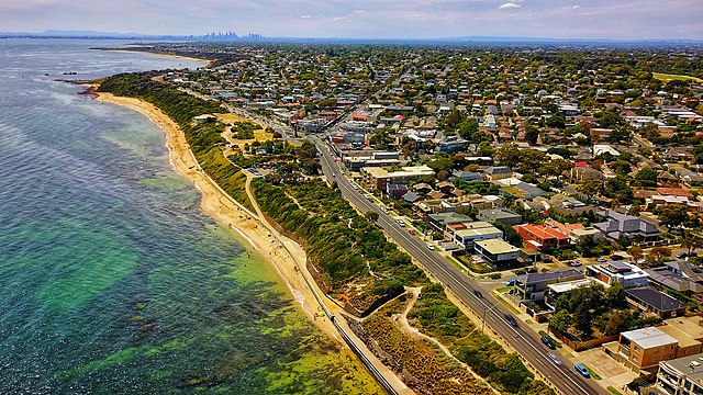 An aerial shot of Port-Phillip Bay, which has lots of homes on the right-hand-side of the picture