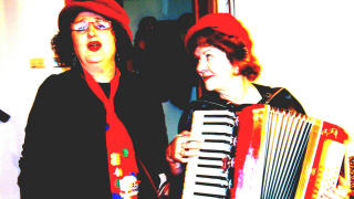 Trish (l) stands with Valerie as part of radical musical group 'Reds Under the Bed'