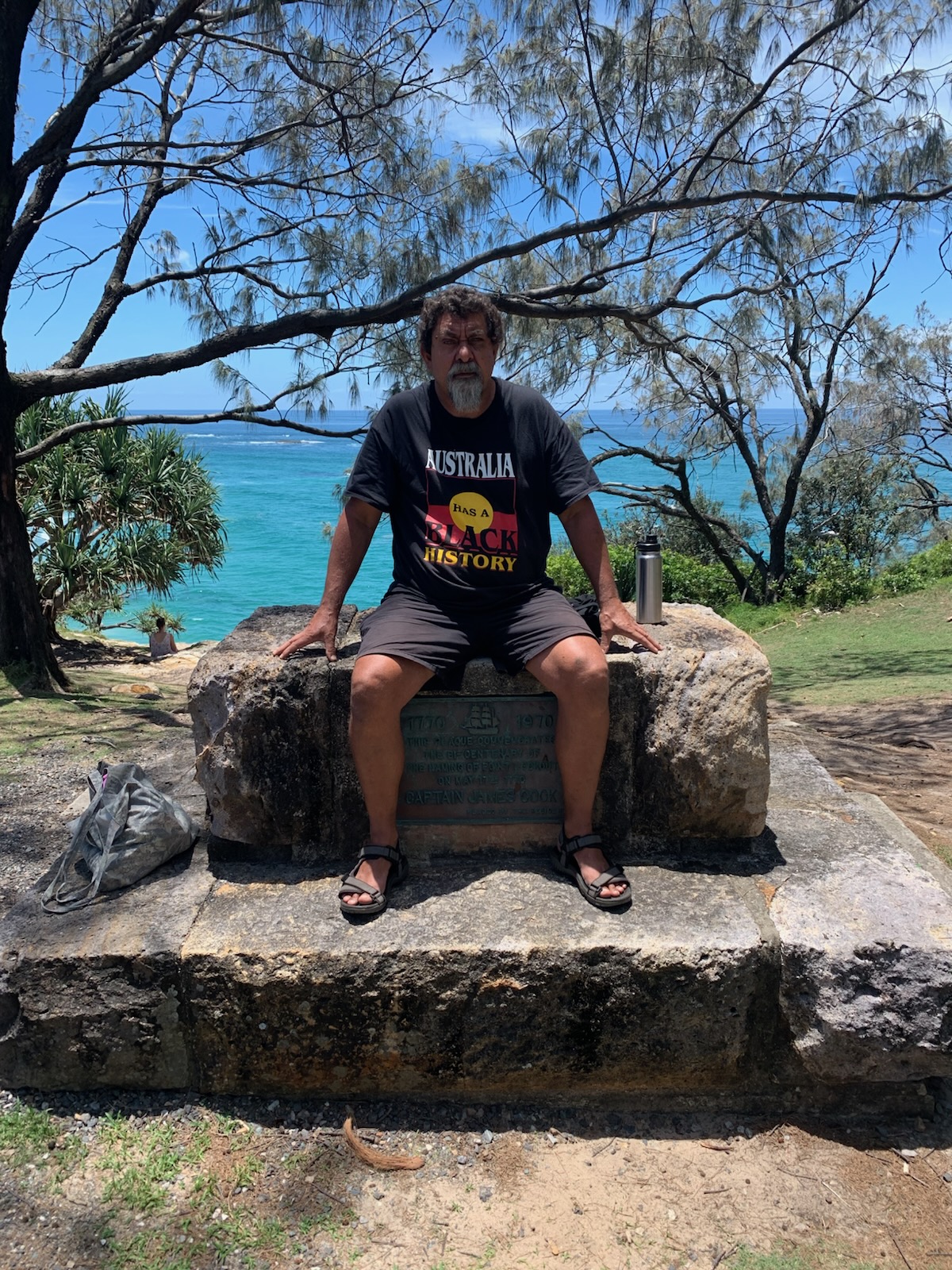 Dale Ruska sits on a monument commemorating cook.