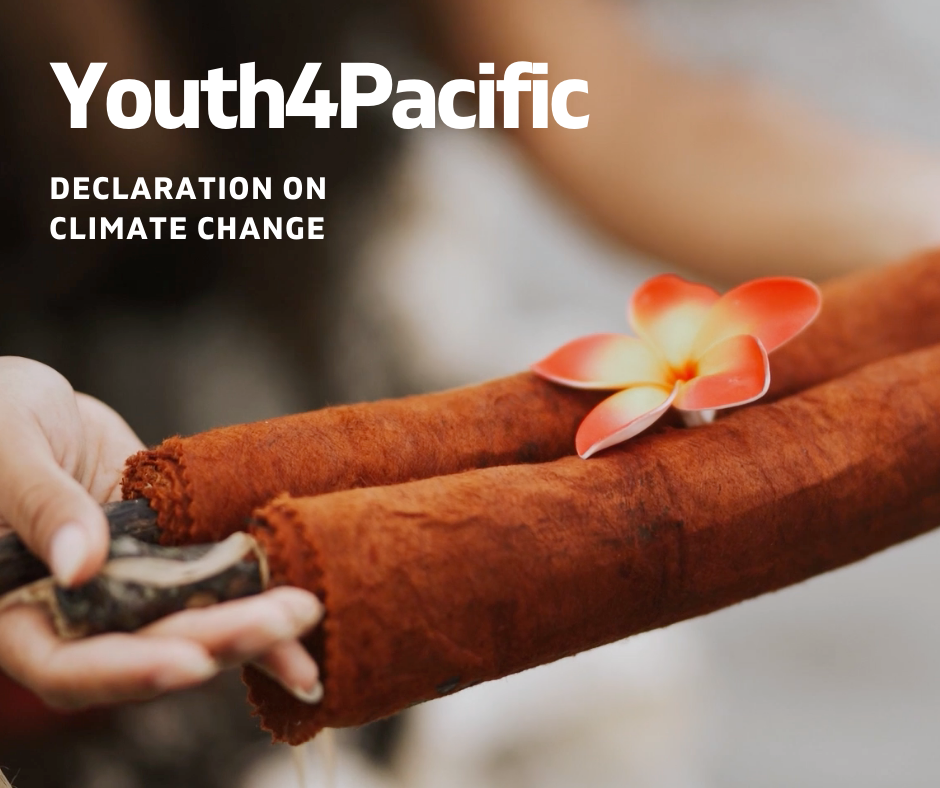 A photograph of two hands holding a brown scroll with a pink and yellow frangipani flower placed on top of it. In the top right in white lettering is written "Youth4Pacific Declaration on Climate Change.