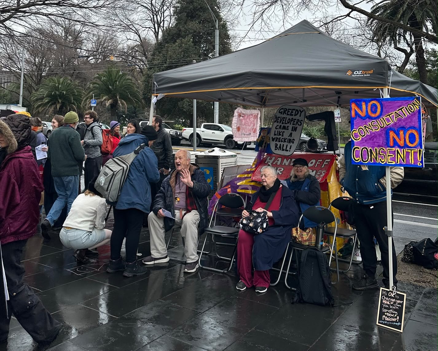 Older public tenants and supporters gather outside Housing Minister Nick Staikos' office at 1 Spring Street on the 5th of August, 2026.