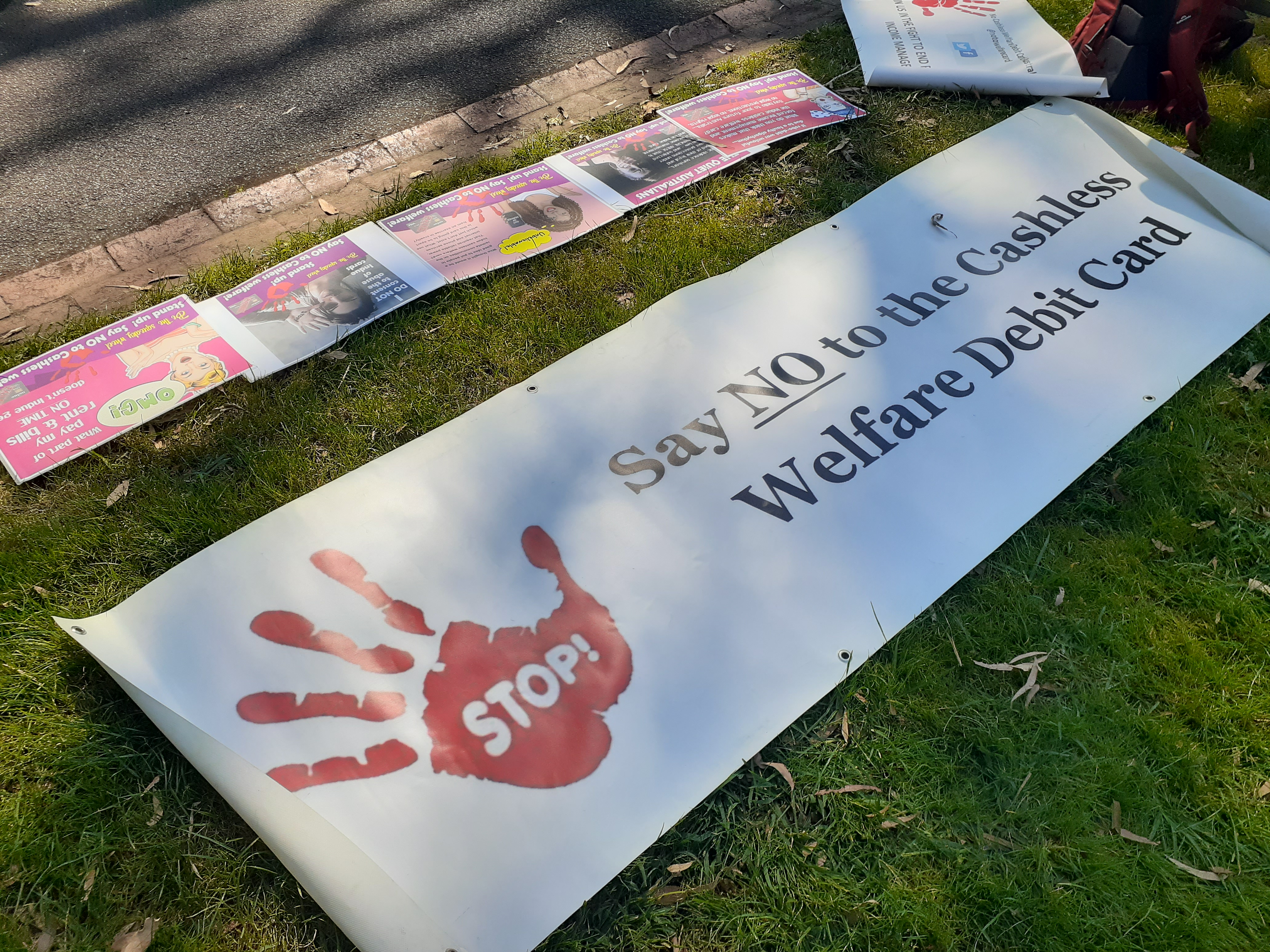 Banner at Breaking the Poverty Machine Rally March 2021