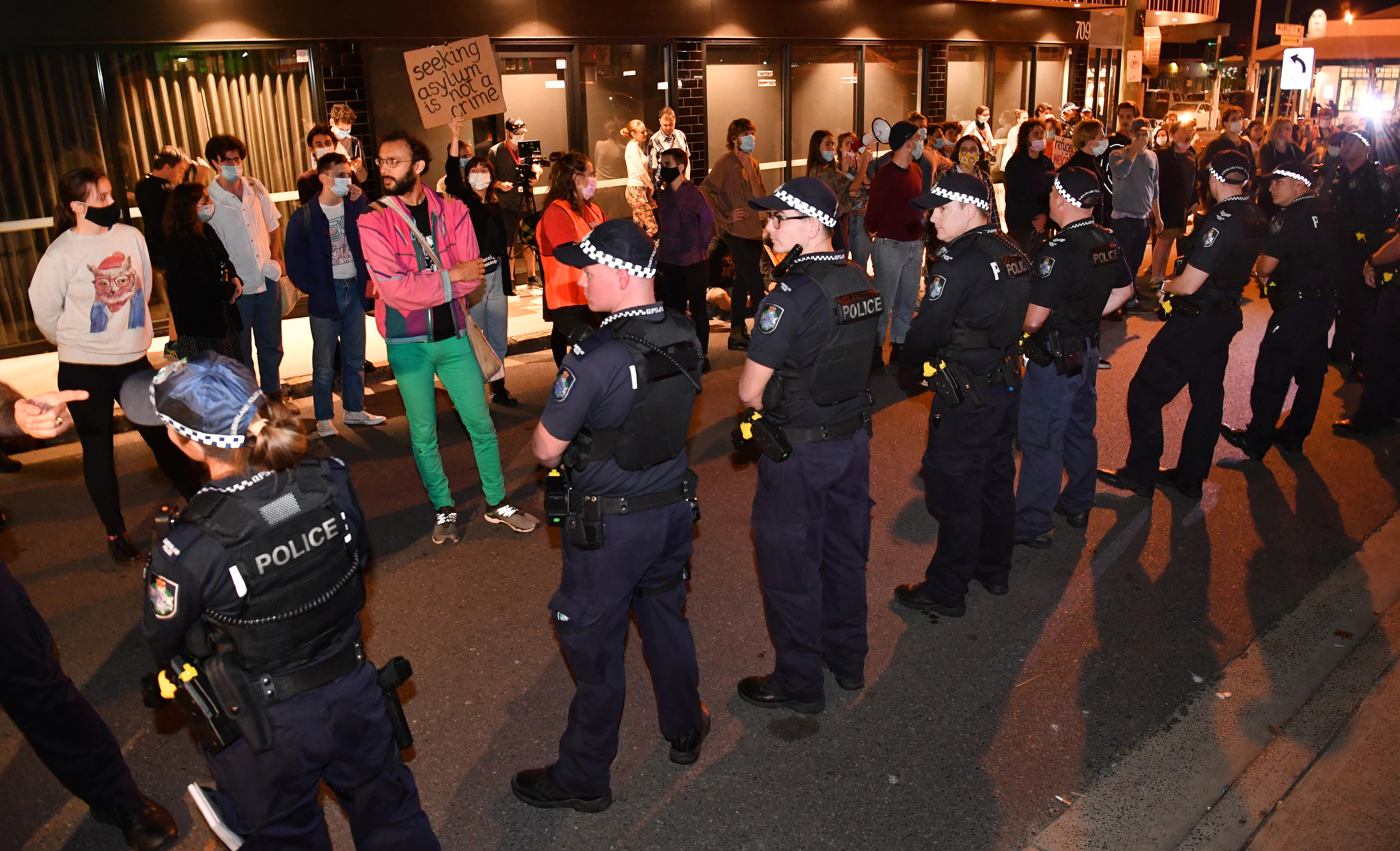 Protesters face off against the police line at the Kangaroo Point blockade