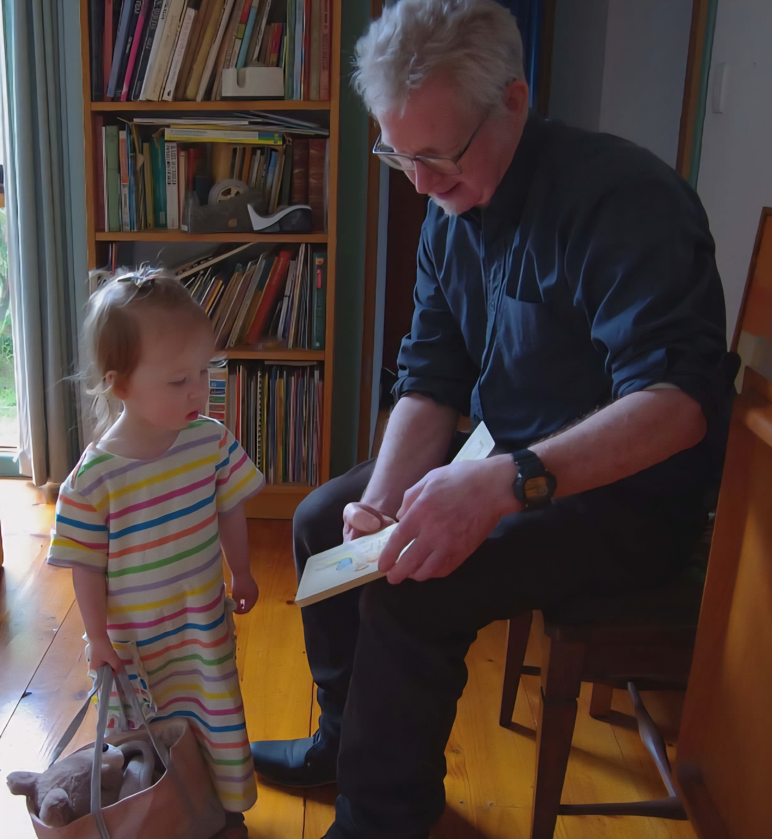 Photo of Chris reading to his niece. Photo supplied by Tim Rust. 