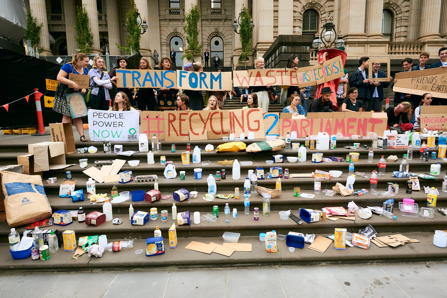 Protesters bring their recycling to the steps of Parliament