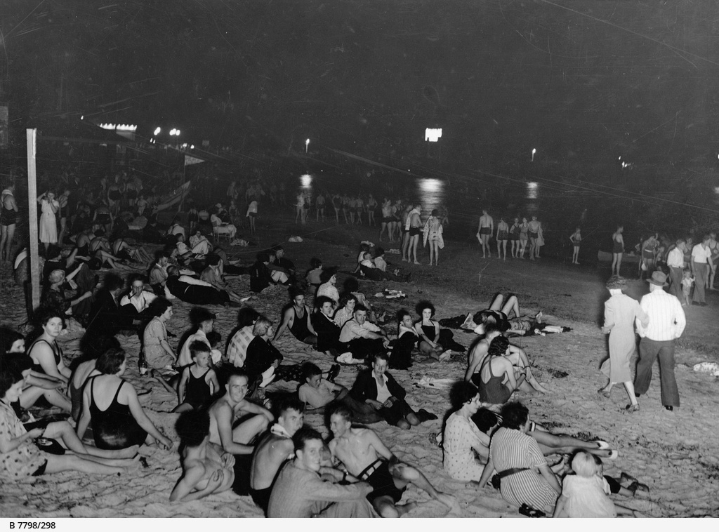 View of Glenelg Beach taken on a hot February night showing bathers seeking relief from the heat.