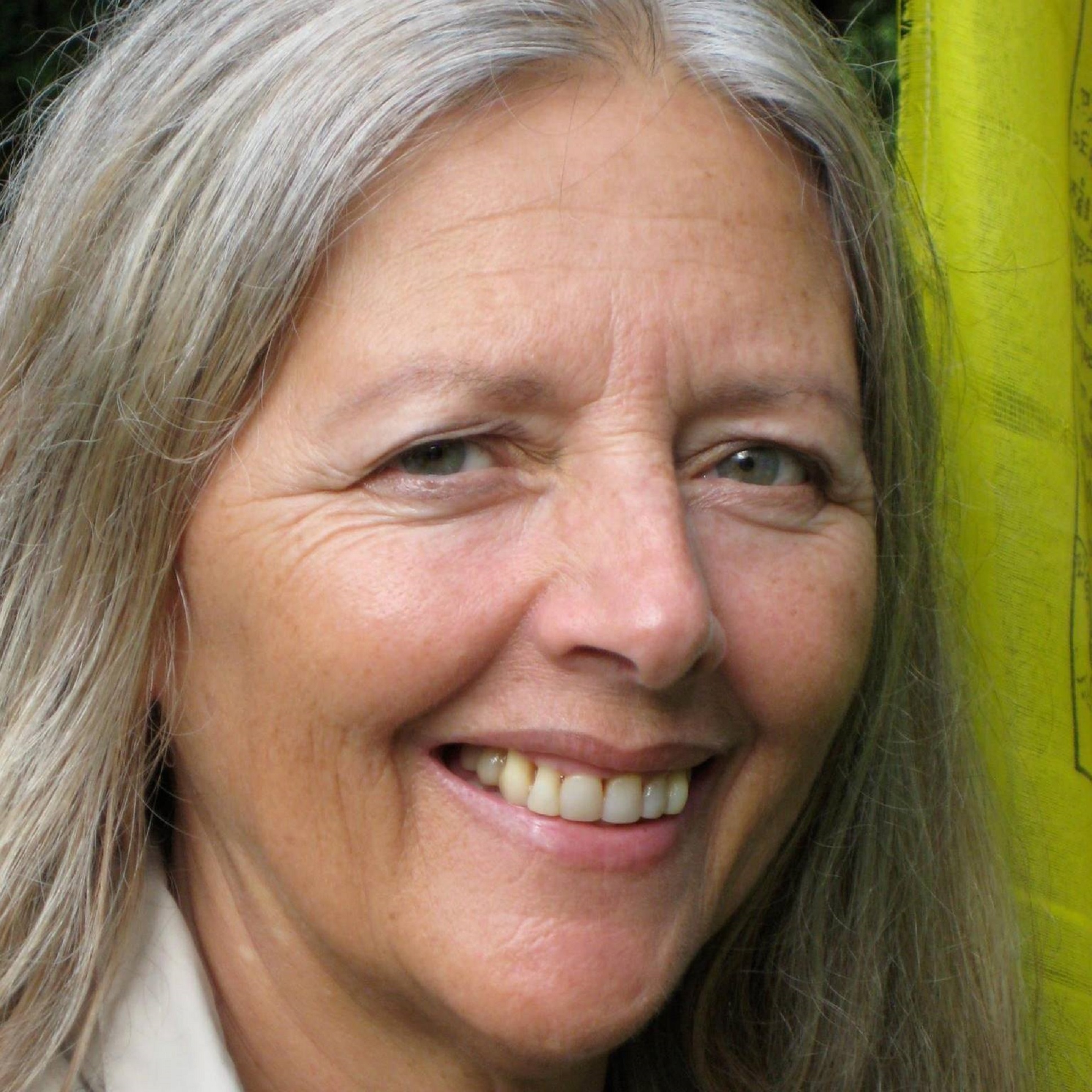 A women with silver hair and smiling blue eyes.