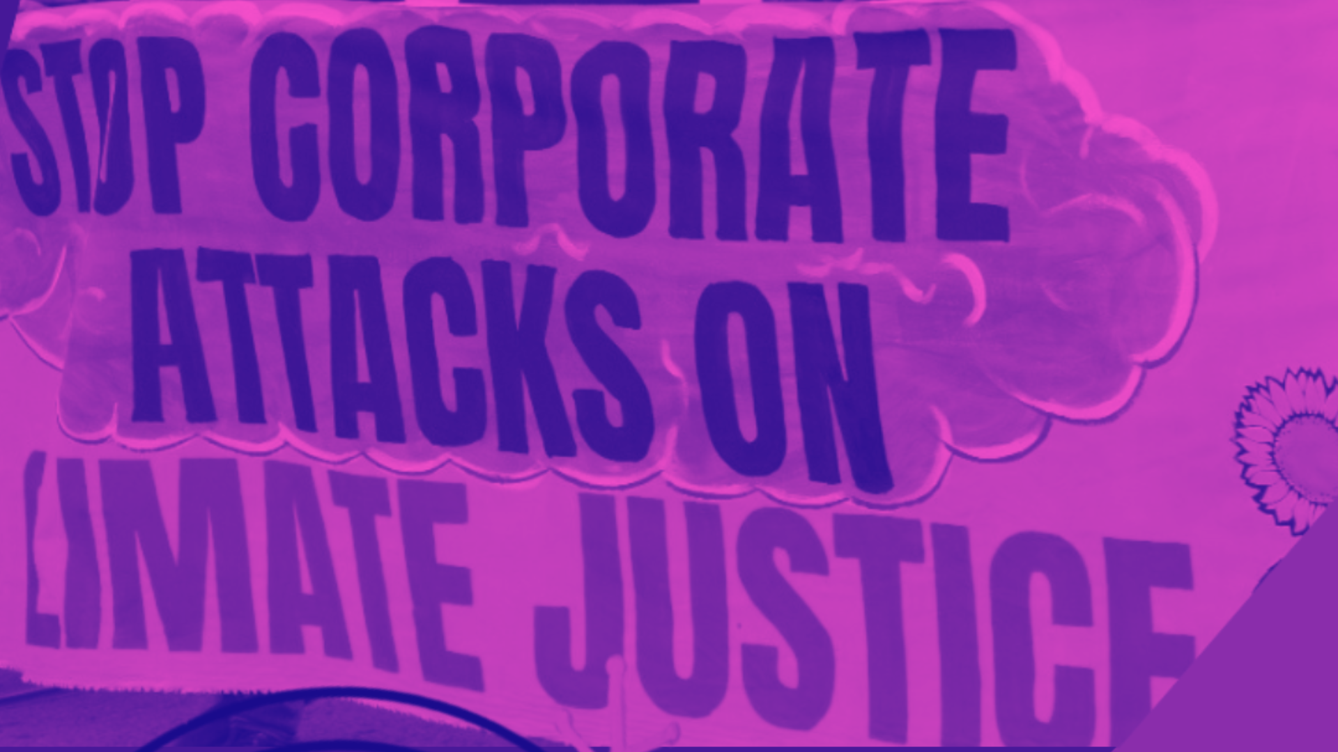 Colour-altered (pink and purple) photgraph of a protest banner reading 'Stop Corporate Attacks on Climate Justice'