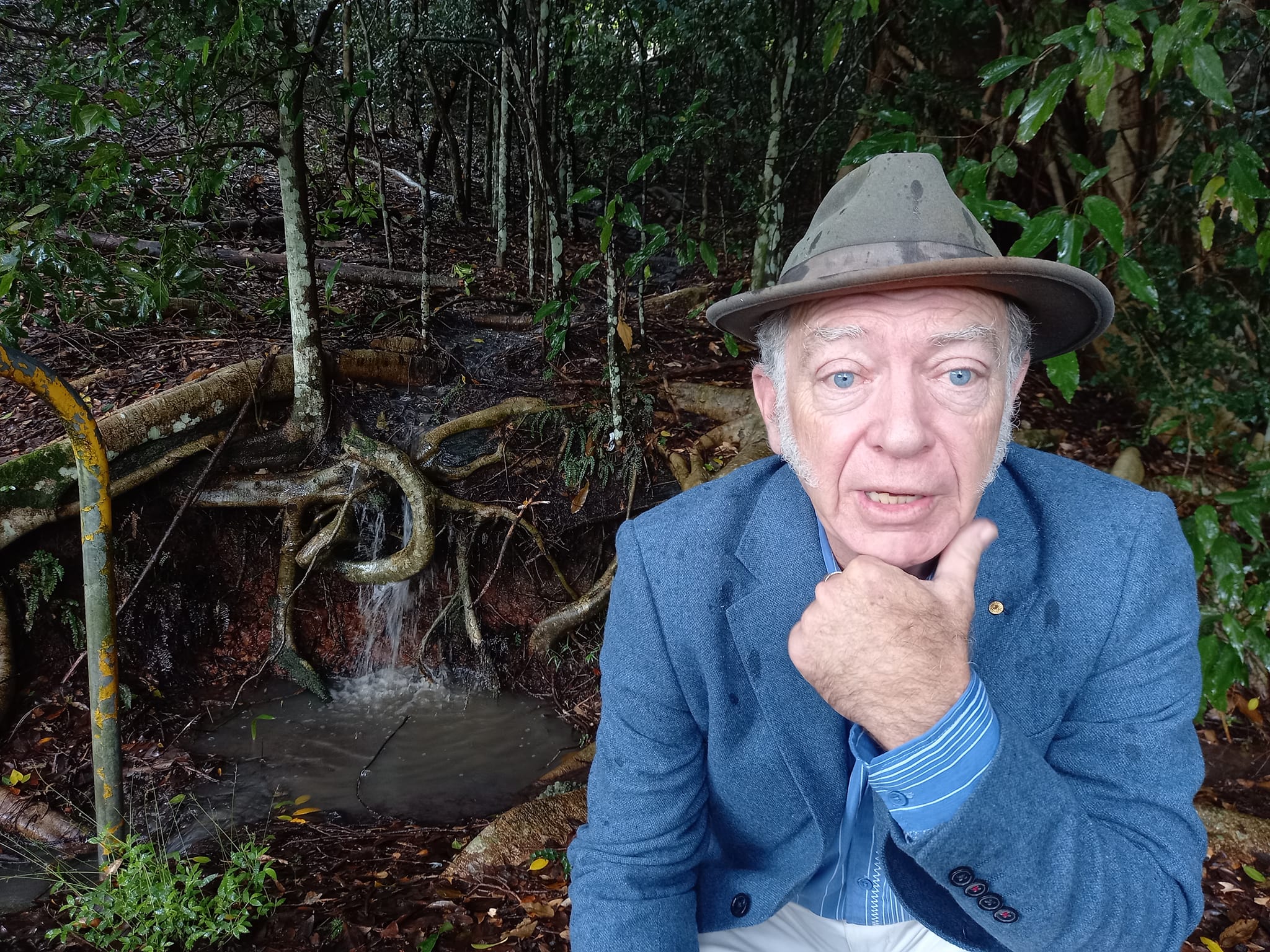Dr Corkill by a creek at a Rotary Park rainforest reserve, Lismore. 