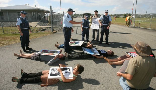 Robin Taubenfeld (bottom left) and others blocking the entrance to Camp Rocky as a part of the Talisman Sabre war games protests