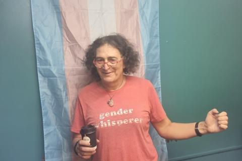 Sally Goldner in pink t-shirt with gender whisperer in trans colours