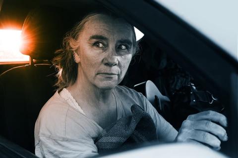 Penelope Swales at steering wheel in car