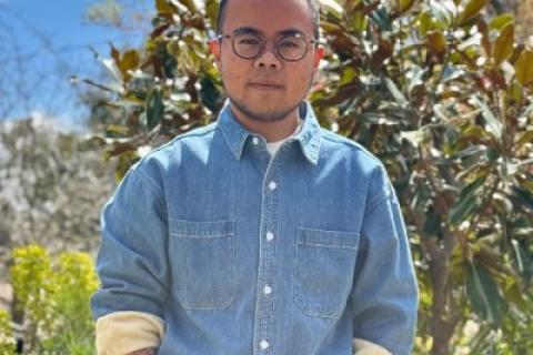 Man dark hair dark-rimmed glasses blue denim shirt very trimmed beard