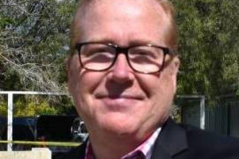 headshot of Brian Greig wearing glasses