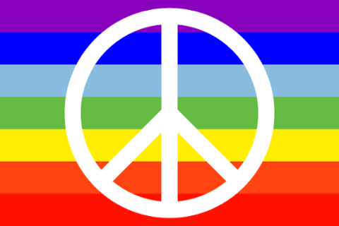 white peace symbol over rainbow colours