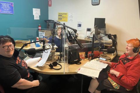 Hosts Margaret and Beth sit in studio 1 as Anarchist World This Week producer, Kelly Whitworth, panels