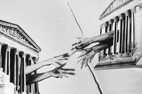 Two pairs of hands reach for each other through prison bars