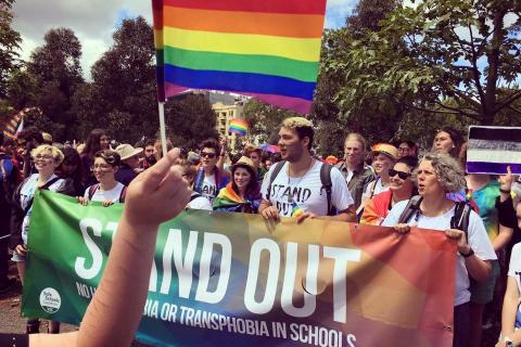 Image of Stand Out group holding rainbow flag