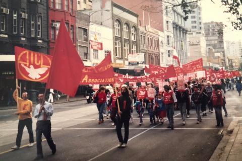 A coloured photograph showing people holding red banners as part of the Australian Turkish Cultural Association (ATCA) at the 1988 May Day march in Narrm.