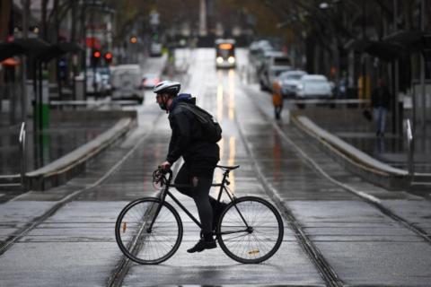 A cyclist on Bourke Street in Melbourne. Image credit: AAP/James Ross