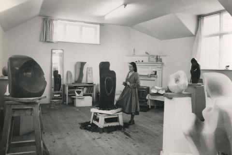 Artist and sculptor Barbara Hepworth looking at a sculptor in progress