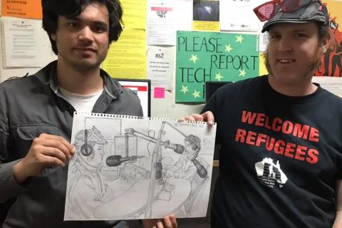 Jacob (L) and Zane Alcorn (Green Left Weekly) at 3CR holding an illustration of themselves in studio