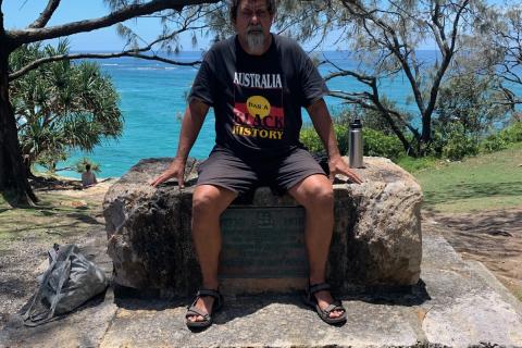 Dale Ruska sits on a monument commemorating cook.