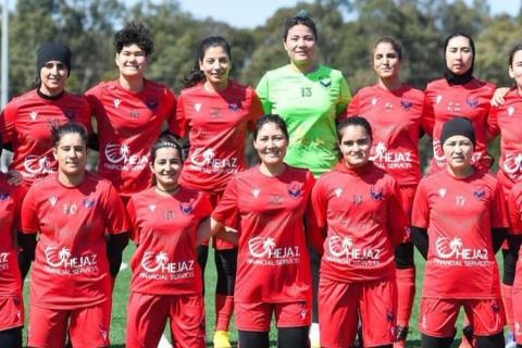 Afghan Women's National Team Club Photo. Red uniforms with goal keeper in bright green. 