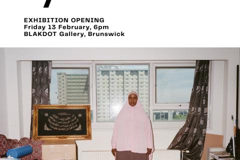 Through Our Eyes, Exhibition Opening, Friday 13th February, 6pm Blakdot Gallery, Brunswick. Image of brown and white living room with woman wearing pink hijab and brown clothing standing in front of window. 