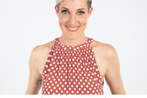 Jo Stanley is a caucasian woman with short blonde pixie hair wearing a red and whiten polka dotted singlet smiling at the camera, Jo has blue eyes. Underneath is the Brainwaves show logo in blue and purple.