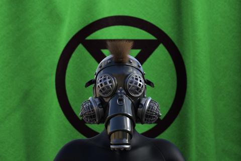 Person with gas mask in front of Extinction Rebellion symbol