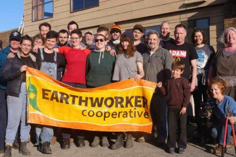 The good folks at Earthworker outside their Morwell factory with an Earthworker banner