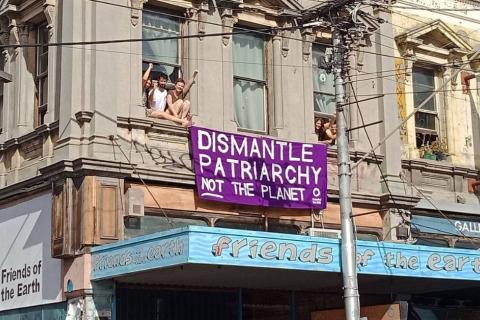 Dismantle patriarchy not the planet - banner hanging from Friends of the Earth's Smith St building