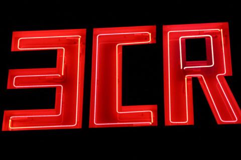 A close up image of a neon sign in block letters which reads: 3CR.