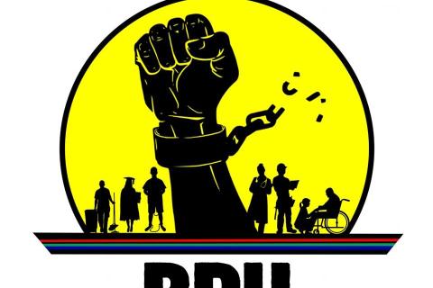 Logo of the Black Peoples Union:  The letters BPU underneath a a digital block-style illustration of a raised fist inside a large circle, bound by a metal cuff and a chain that is beaking off in pieces. The bottom of the circle depicts silhouettes of people in the distance; to the left is a cleaner, university graduate and prisoner, and on the right there is a doctor, a construction worker, and someone crouching before a figure in a wheelchair. 
