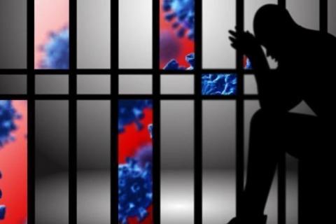Person sitting in a cell with images of COVID-19 virus appearing through the cell bars