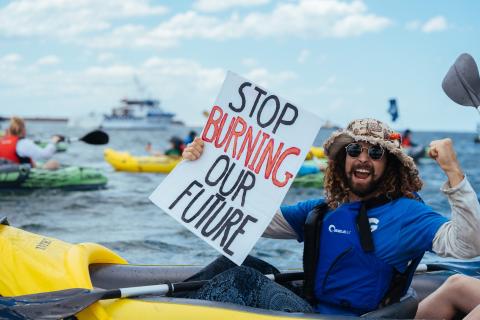 Smiling man in a canooe.